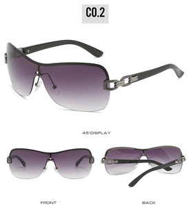 Detail view of oversized sunglasses with purple gradient lenses and chain metal hinges