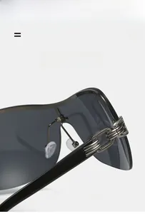 Macro detail of dark gray oversized wraparound sunglasses with silver chain hinge decor