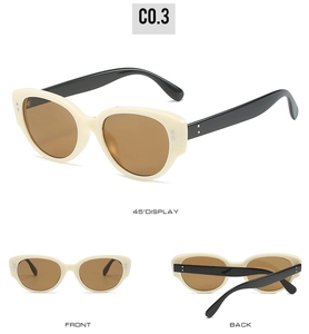 Detailed views of vintage oval sunglasses with cream frames and silver rivet accents
