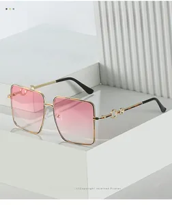 Detail of pink gradient lenses and gold metal frame with unique temple decoration