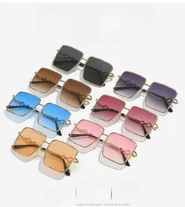 Detail of oversized square sunglasses featuring unique hollow ring temple decorations