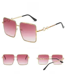 Three angles of square sunglasses with gradient lenses and gold frames