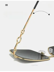 Detailed close-up of golden metal sunglasses frame with circular temple accents