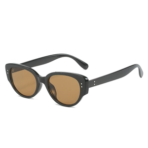 Vintage cat-eye sunglasses with thick black frames, brown lenses, and silver dot accents