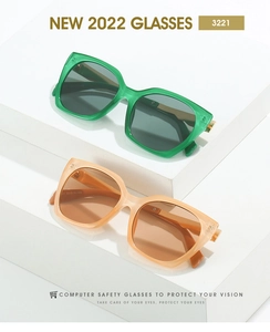 Close-up of square frame sunglasses in green and orange with side temple specifications