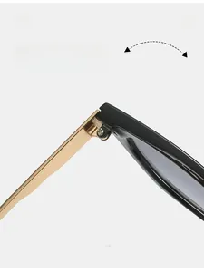Close-up of durable gold metal hinges on square black frame sunglasses for women