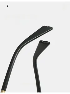 Close-up of curved black polished temples with gold metal hinge detail for extra comfort