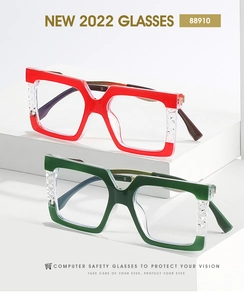 Detail of red and green square anti-blue light glasses with textured diamond hinge design