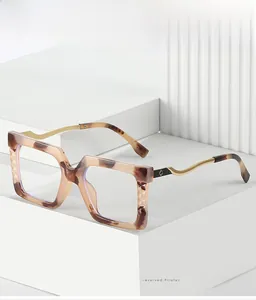 Detailed macro view of square tortoiseshell frames with decorative gold metal temples