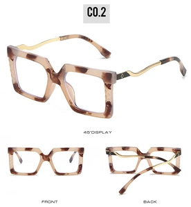 Detail showing tortoiseshell square frames with wavy gold metal temples and accents