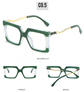 Detail view of large green square frames with crystal accents and golden wavy temples