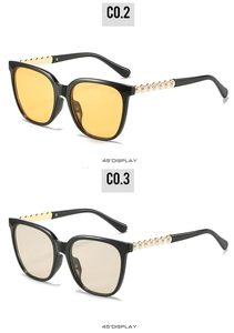 Detail view of cat-eye sunglasses with pearl-embellished wave temples and tinted lenses
