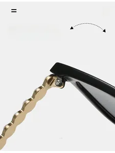 Detail of durable gold metal wave hinges and black frame on cat eye sunglasses