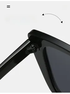 Detailed close-up of a durable reinforced hinge on black oversized cat-eye sunglasses