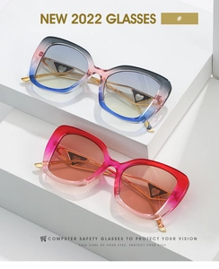 Détail de lunettes œil-de-chat rétro avec verres dégradés bleu-rose et rouge-rose sur socle