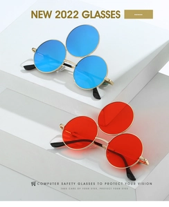 Detailed close-up of triple-lens steampunk sunglasses with gold frames on white background