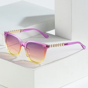 Cat eye sunglasses with purple gradient lenses and pearl decorated metal temples