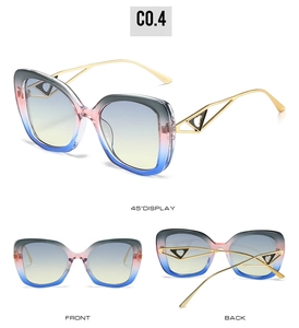 Détail des lunettes de soleil œil de chat avec branches dorées en cœur et verres dégradés