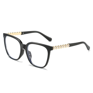 Cat eye sunglasses with black frame and gold metal temples featuring pearl embellishments