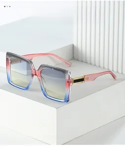 Detailed macro of gradient frame sunglasses with gold hardware on white display