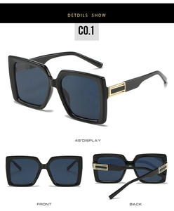 Detail of square sunglasses with gold metal stripes on temples and dark blue lenses
