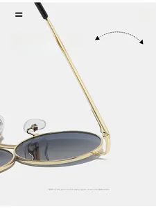 Detail of durable gold metal hinge on round sunglasses showing smooth folding mechanism