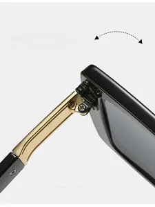Detailed macro view of the sturdy gold metal hinge on minimalist black square sunglasses