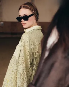 Chic women's square sunglasses paired with a lace shirt and delicate pearl detailing