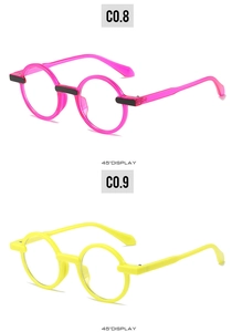 Detail of round frame sunglasses in bright pink and yellow with 45-degree angle display