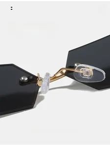 Detailed macro of adjustable silicone nose pads and gold metal bridge on frameless sunglasses