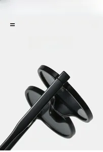 Detail of round black sunglasses showing flexible hinges and premium glossy frame texture