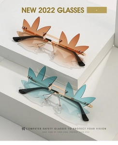 Macro detail of leaf-shaped rimless sunglasses with gradient lenses and gold metal frames