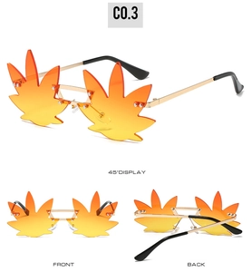 Detail view of leaf-shaped rimless sunglasses with orange gradient lenses and gold temples