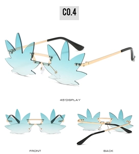 Detail view of leaf-shaped gradient blue lenses and gold metal frame sunglasses