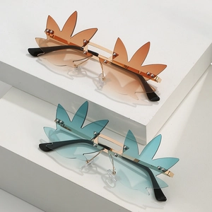 Fashionable leaf-shaped rimless sunglasses in amber and cyan with gold metal bridge