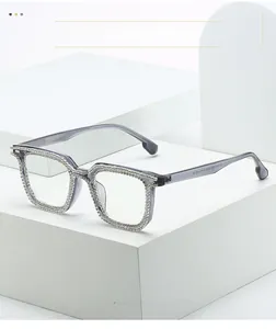 Macro detail of square grey resin eyeglass frame with sparkling silver rhinestones
