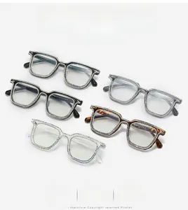 Detail view of five square diamond-studded glasses in black, clear, and tortoiseshell colors
