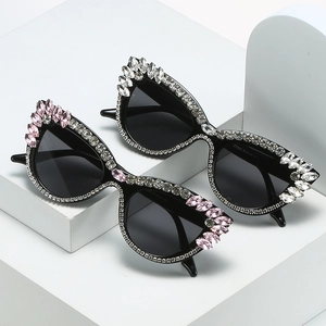 Cat eye sunglasses with luxury rhinestones in white and pink on black frames