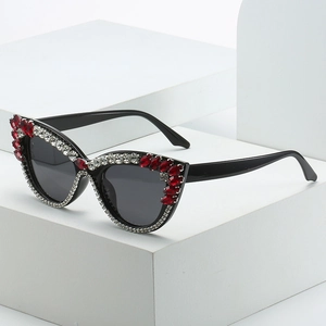 Fashion cat-eye sunglasses with rhinestone detailing on a minimalist geometric display