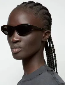 Close-up of stylish tortoiseshell cat eye sunglasses worn by model for a retro punk aesthetic