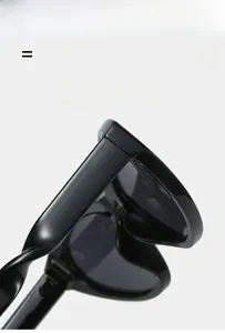 Detail of glossy black punk cat eye sunglasses featuring unique twisted elastic temples