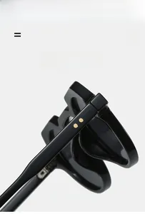 Detail of high-quality polished black temple with parallel gold metal decorative studs