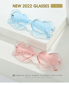 Detail of candy-colored heart sunglasses in blue and pink on a white tiered display