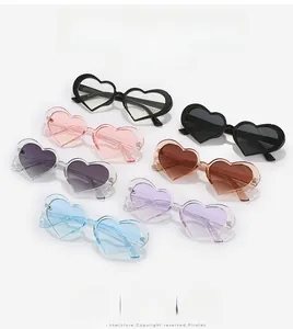 Flat lay of heart-shaped sunglasses in six trendy candy colors with PC ocean lenses