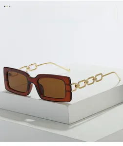Detailed macro view of the gold chain temple design on brown square sunglasses