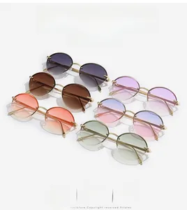 Detailed view of oval rimless sunglasses in multiple gradient colors with gold metal frames