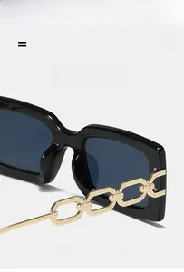 Detail of square black sunglasses showing elegant gold chain temple design and sturdy hinges