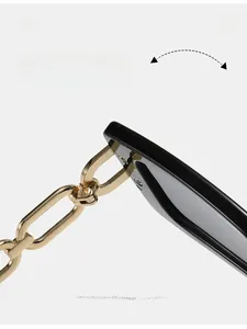 Macro view of durable texture hinge and golden metal chain temple on black sunglasses