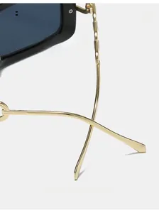 Detail of curved gold metal mirror legs on stylish square frame sunglasses for comfort