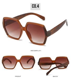 Macro detail of amber wood grain texture on oversized geometric sunglasses frames